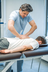 Male patient having a session of rehabilitation back massage