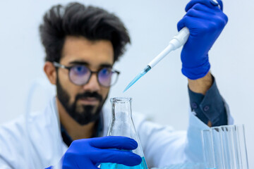 Fototapeta premium Portrait of male scientist working analysis liquid sample in laboratory flask