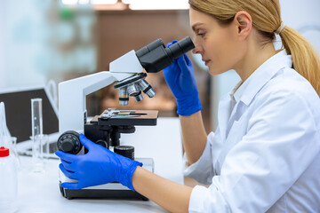 Researcher working in laboratories, uses microscopic, analyzes information of virus in laboratory.