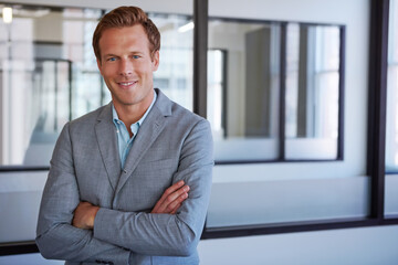 Confidence leads to success. Cropped portrait of a businessman standing with his arms folded in his office.