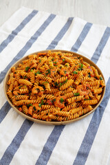 Homemade Creamy Tomato Shrimp Rotini Pasta with Parsley on a Plate, side view.