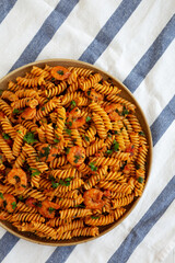 Homemade Creamy Tomato Shrimp Rotini Pasta with Parsley on a Plate, top view. Flat lay, overhead, from above. Close-up.