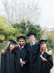 Theyve forged lifelong bonds. A group of college graduates standing in cap and gown and holding...