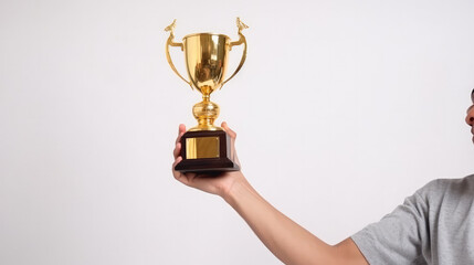 Single golden trophy as a symbol for the winner in front of a white background in the hand of a person. Generative AI.