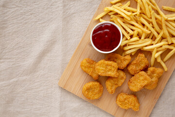 Naklejka premium Chicken Nuggets and French Fries with Ketchup Ready to Eat. Flat lay, overhead, from above.