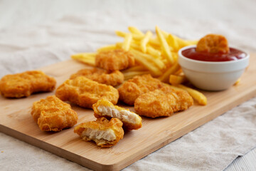 Chicken Nuggets and French Fries with Ketchup Ready to Eat, side view.