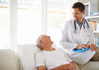 Fototapeta premium Youre doing great. a handsome male doctor with a happy elderly patient.