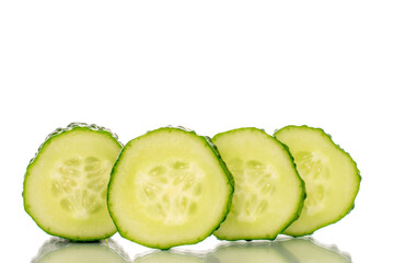 One ripe cucumber gherkin cut into slices, macro, isolated on white background.