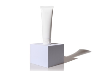 White plastic cosmetic tube with cosmetic cream. For body and face.
