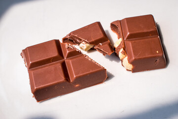 Cholocate bar with peanuts on white background