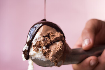 Hand holding an ice cream scoop with ice cream  