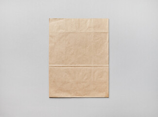 Blank kraft paper pack on gray paper background. Responsive design mockup. Flat lay.