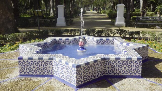 Slow motion video of Andalusian tile fountain in Maria Luisa Park, Seville