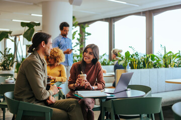 Coworkers on coffee break in cafeteria.