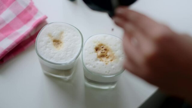 Woman makes coffee latte in geyser coffee maker at home