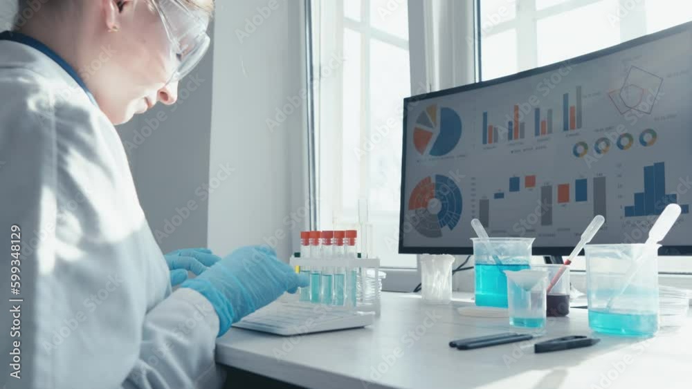 Poster Medical researcher uses a computer program to process large amounts of medical data in a laboratory. The scientist enters data from experiment into computer system and analyzes results in laboratory.