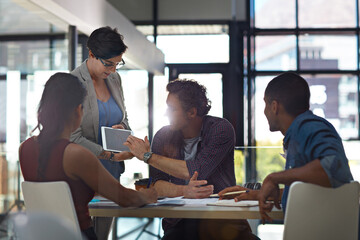 Sharing an idea with the group. a group of colleagues meeting in the office.