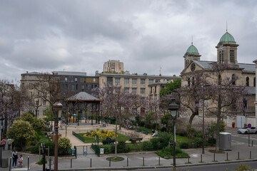 Fototapeta premium Paris, France - 05 01 2023: Flandres district. View of the Square Serge Reggiani and Church of Saint-Jacques-Saint-Christophe.