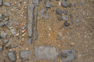 imagen detalle textura suelo de tierra con piedras enterradas de distintos tamaños, formas y colores 