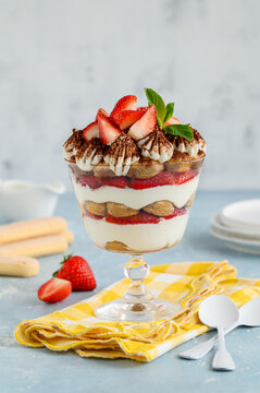 Italian tiramisu with strawberries in a glass bowl. Summer berry dessert. Selective focus