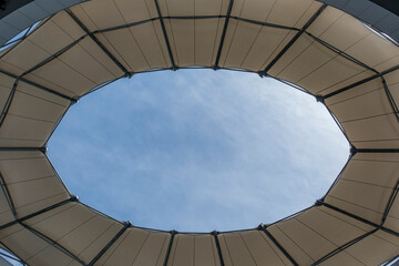 Bottom view of the building's tarpaulin roof. Sky view from building roof