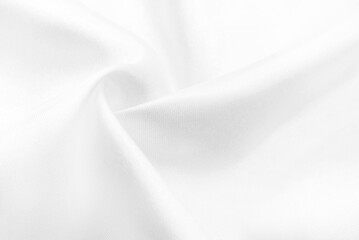 A twisted piece of white fabric. White material or texture with waves and folds. Wrinkled white fabric