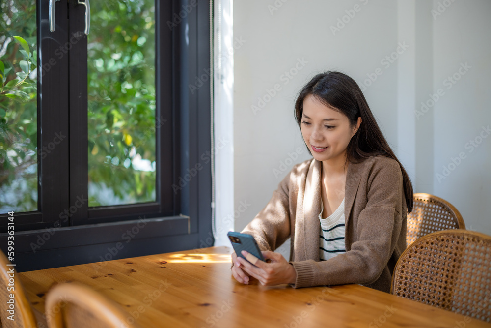 Canvas Prints Woman use mobile phone inside coffee shop