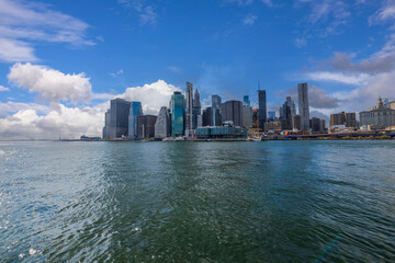 Beautiful view of Manhattan skyscrapers against blue sky with white clouds. New York. USA. 