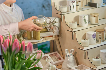 experienced artisan presents a meticulously crafted, handmade candle. Embracing Artisanal Traditions: The Resurgence of Handcrafted Candles and Community Markets