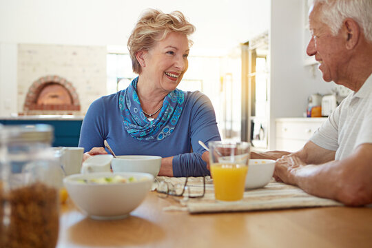 Mornings are better when I start them with you. a happy mature couple having breakfast together in their kitchen at home.