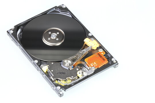 Close up view of internal computer hard drive 2.5" SAS, can see disk surface and head with shallow focus isolated on white background.