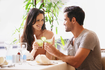 Celebrating their anniversary at a lovely restaurant. A young couple in a restaurant.