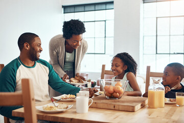 Mornings can be enjoyable when having breakfast with your family. a family having breakfast together at home.