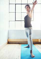 Yoga - the perfect exercise with surprising health perks. an attractive young woman practising yoga at home.