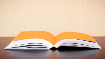 An open book on a table against the wall, a copy of the space