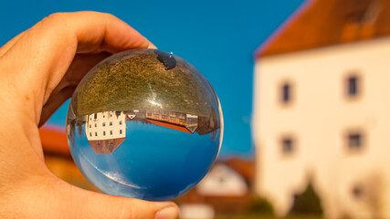 Crystal ball landscape shot with buildings at Herrnfehlburg, Rattiszell, Bavarian forest, Straubing-Bogen, Bavaria, Germany