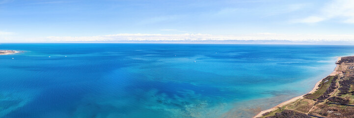 Fototapeta na wymiar erial panoramic view of the vivid blue waters of Lake Issyk-Kul
