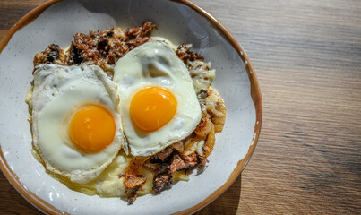 Fried Eggs, Steak, Onions, atop Grits