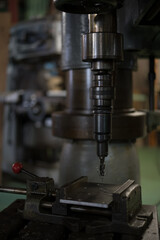 Fototapeta na wymiar Thread cutting with a radial drilling machine