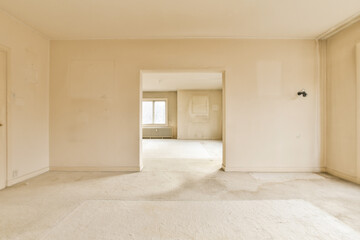 an empty room with white walls and no one person standing in the doorway, or door to the other room