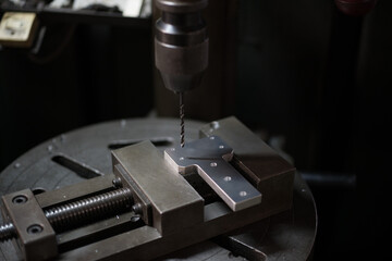Part machining with drilling machine