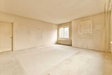 an empty room with white walls and no one person standing on the floor looking out to the other area in the room