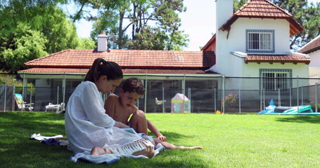 Fototapeta premium Mother and kid together in backyard home garden lawn