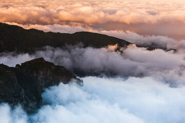Madeira mountains landscape with peaks above clouds at sunset