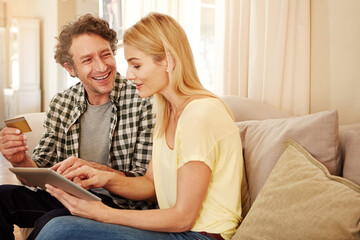 What should we buy. a loving couple shopping online on their tablet.