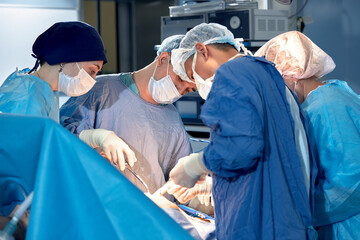 International team of surgeons in the operating room during the operation. Modern medicine, international medical workers during a complex operation