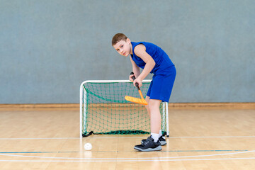 Floorball child boy player with stick and ball. Horizontal sport theme poster, greeting cards,...