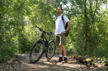Man in forest with bicycle