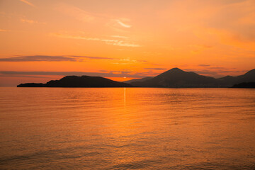 Naklejka na ściany i meble Golden sunset in Montenegro city of Budva on the beach of St. Stephen