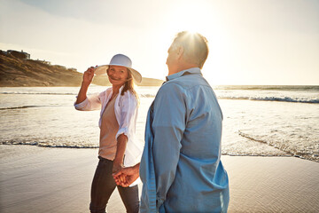 Dont go a day without making your spouse feel special. a mature couple spending the day at the beach.